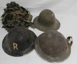 A collection of four military helmets, comprising two Mk II Brodie helmets, a WW2 Warden's helmet,