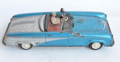 Vintage West German lithographed pressed steel push along friction powered car model with working