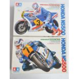 Two unbuilt 1/12 scale Honda NS500 motorcycle plastic model kits with included driver figures from
