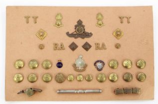 Card containing collection of brass buttons, cap badge shoulder titles for the Royal Artillery. Home