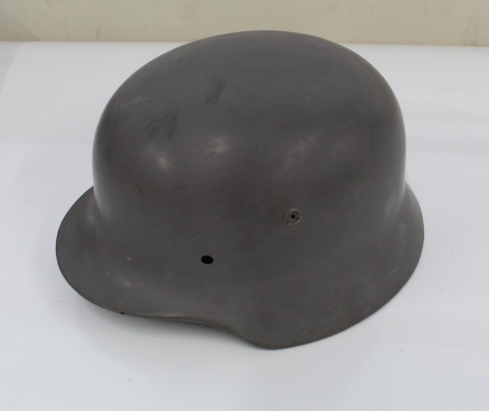 WW2 German steel helmet, lacking liner and repainted in battleship grey.