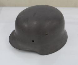 WW2 German steel helmet, lacking liner and repainted in battleship grey.