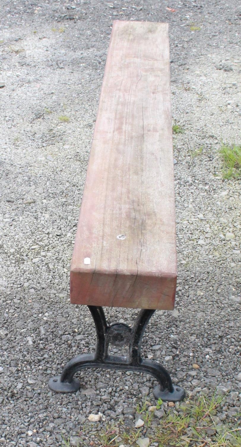 Large garden bench/form with cast iron legs and heavy wooden seat. 199cmx50cm - Image 2 of 2