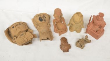 Collection of terracotta clay antiquities from various civilizations, including a South American