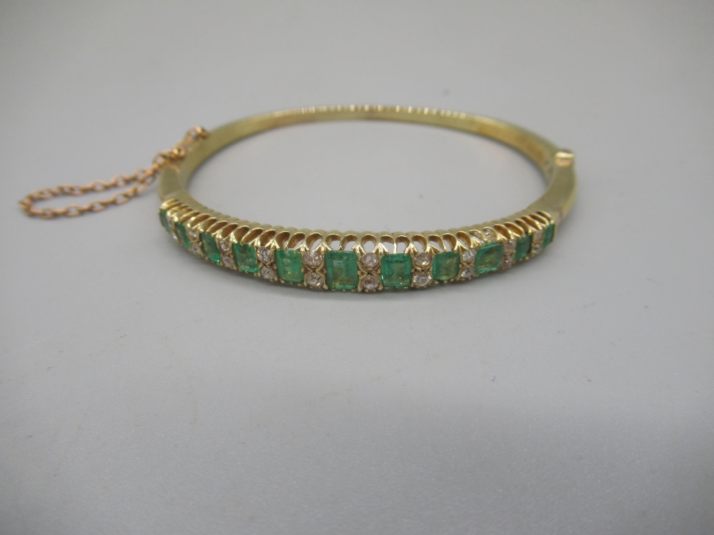 15ct yellow gold hinged bangle set with graduated emeralds cut emeralds and brilliant cut