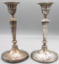 Pair of Edwardian silver neoclassical style candlesticks with reeded bases, urn sconces on ovoid