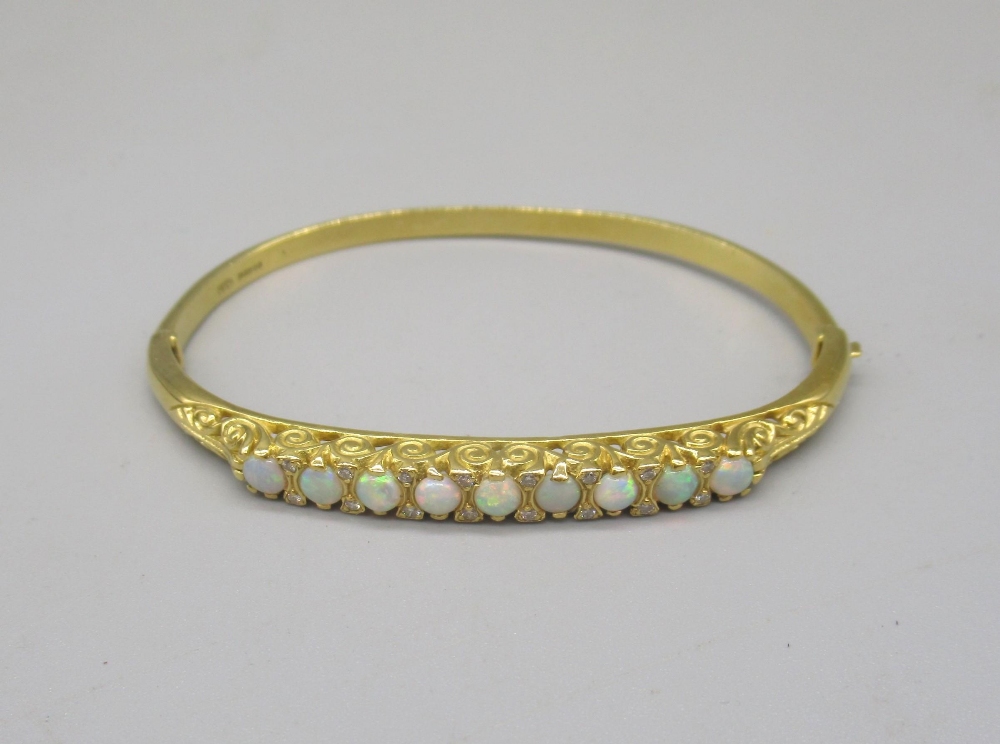 18ct yellow bangle set with nine opals between brilliant cut diamonds on scroll mount, stamped - Image 3 of 12