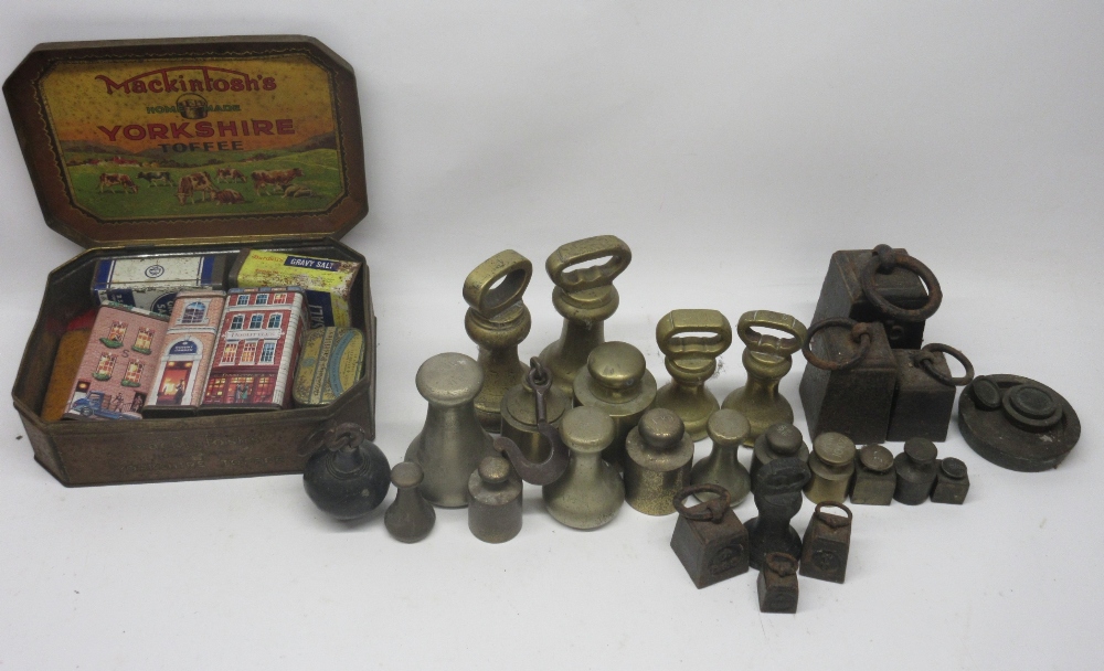 Four brass bell grocery weights; other brass grocery weights; cast iron grocery weights and