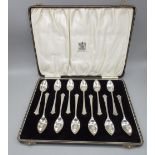 ER.II Cased set of twelve hallmarked Sterling silver grapefruit spoons with H initial engraved to