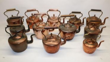 Twelve Victorian copper kettles all with acorn finials, H28.5cm (2)