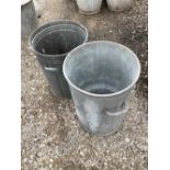 Two metal dustbins for use as planters and garden decor