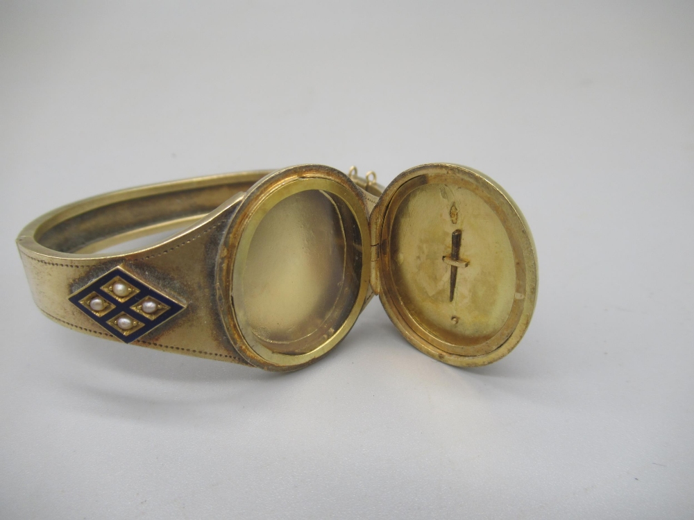 Victorian yellow metal and blue enamel mourning bangle set with pearls, the centre opening to reveal - Image 4 of 9