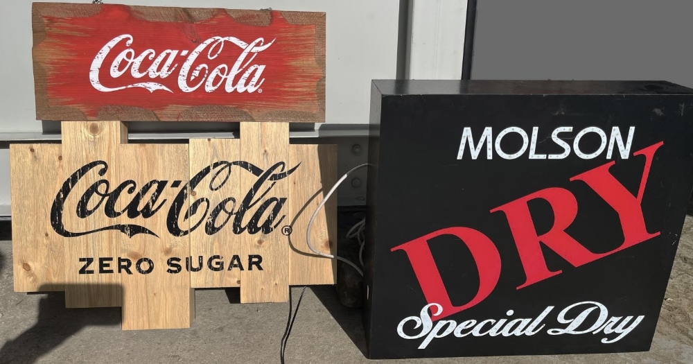 Three contemporary bar signs, comprising two wooden Coca-Cola signs, and an illuminated Molson Dry