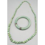 Jade bead necklace with 9ct yellow gold clasp, stamped 375, L73cm, and a carved jade bangle