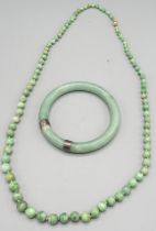 Jade bead necklace with 9ct yellow gold clasp, stamped 375, L73cm, and a carved jade bangle