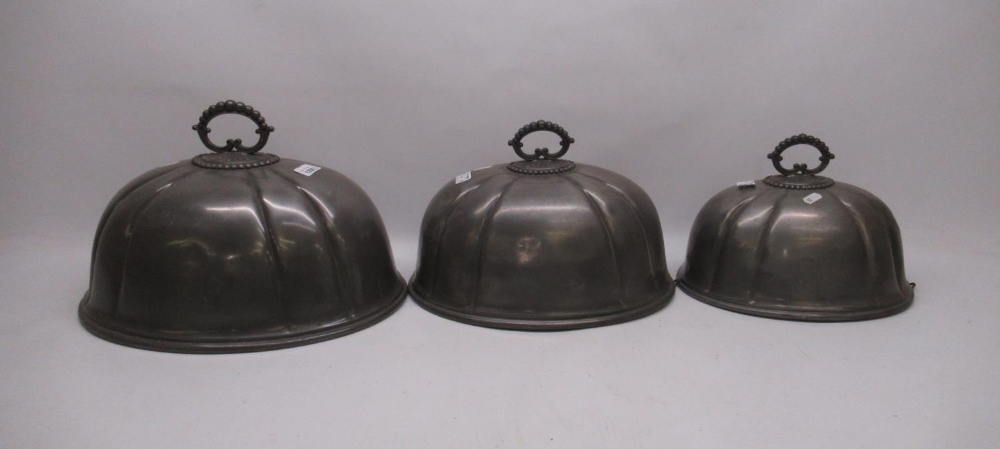 Three pewter graduated meat covers W41cm