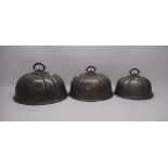 Three pewter graduated meat covers W41cm