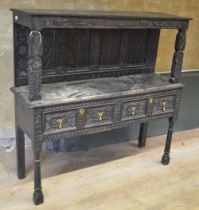 18th century and later oak dresser, raised back with four flower carved panels, above two drawers,