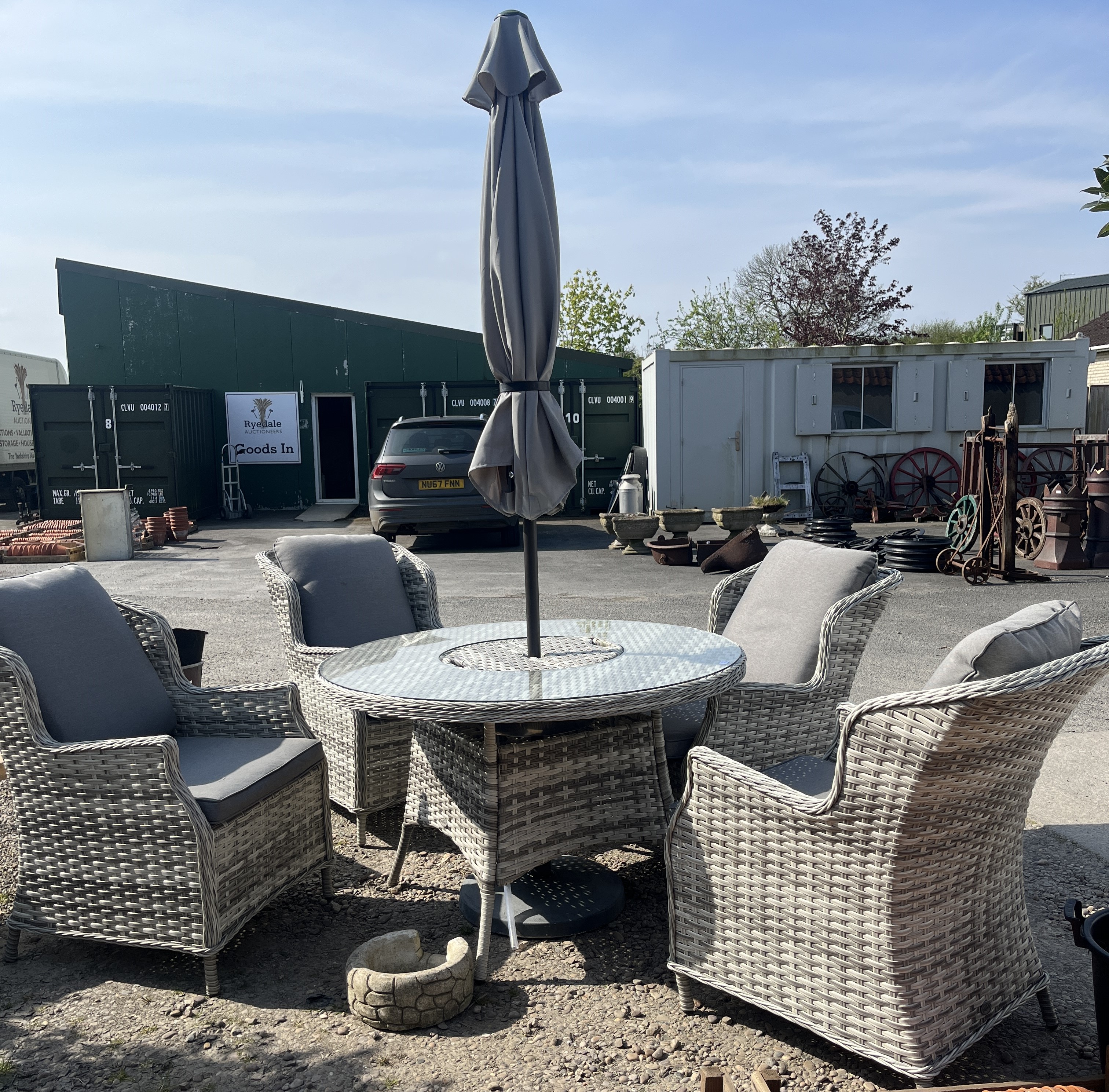 Rattan patio set comprising of large circular table with glass top and central reservoir, 4 matching