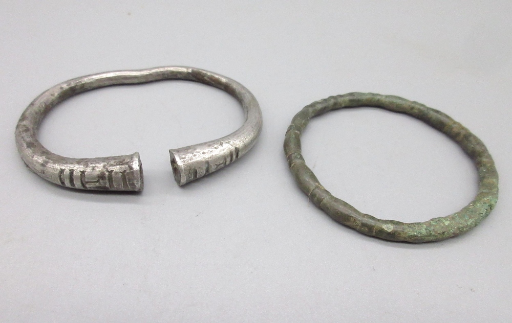 Ancient Persian silver bracelet with linear incised decoration (approx. 400BC), and another metal (