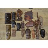 A large collection of wooden masks and carvings of various ages and styles, originating from