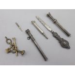 Yellow metal fob charms and key, two Victorian white metal propelling pencils and other white