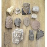 Collection of carved stoneware to include faces, a wolf head, one composite head on plinth, etc. (
