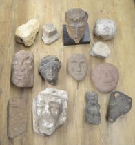 Collection of carved stoneware to include faces, a wolf head, one composite head on plinth, etc. (