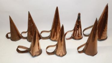Eight 19th century copper ale warmers with riveted strap handles, H21.5cm