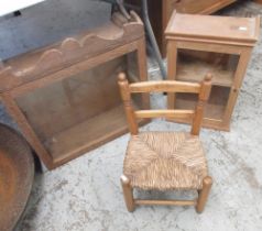 Glazed oak wall cupboard, similar glazed pine cupboard and a child's rush seat ladder back chair,