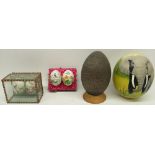 Decorated ostrich eggs, on turned wooden stand, 14cm and other decorated eggs