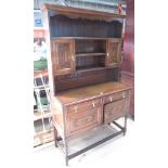 C20th oak dresser, twin shelf back with two cupboards above two further cupboards and two drawers,
