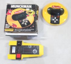 Two vintage hand held computer games, comprising Grandstand Munchman with box, and a CGL Galaxy