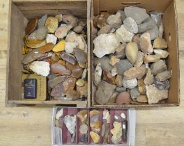 Collection of neolithic flint and stone hand tools including microliths and arrow heads, rocks
