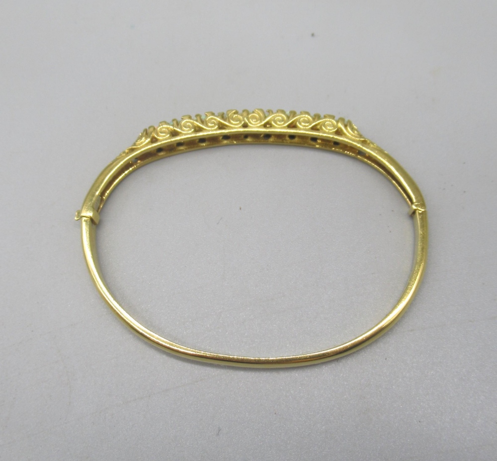 18ct yellow bangle set with nine opals between brilliant cut diamonds on scroll mount, stamped - Image 6 of 12