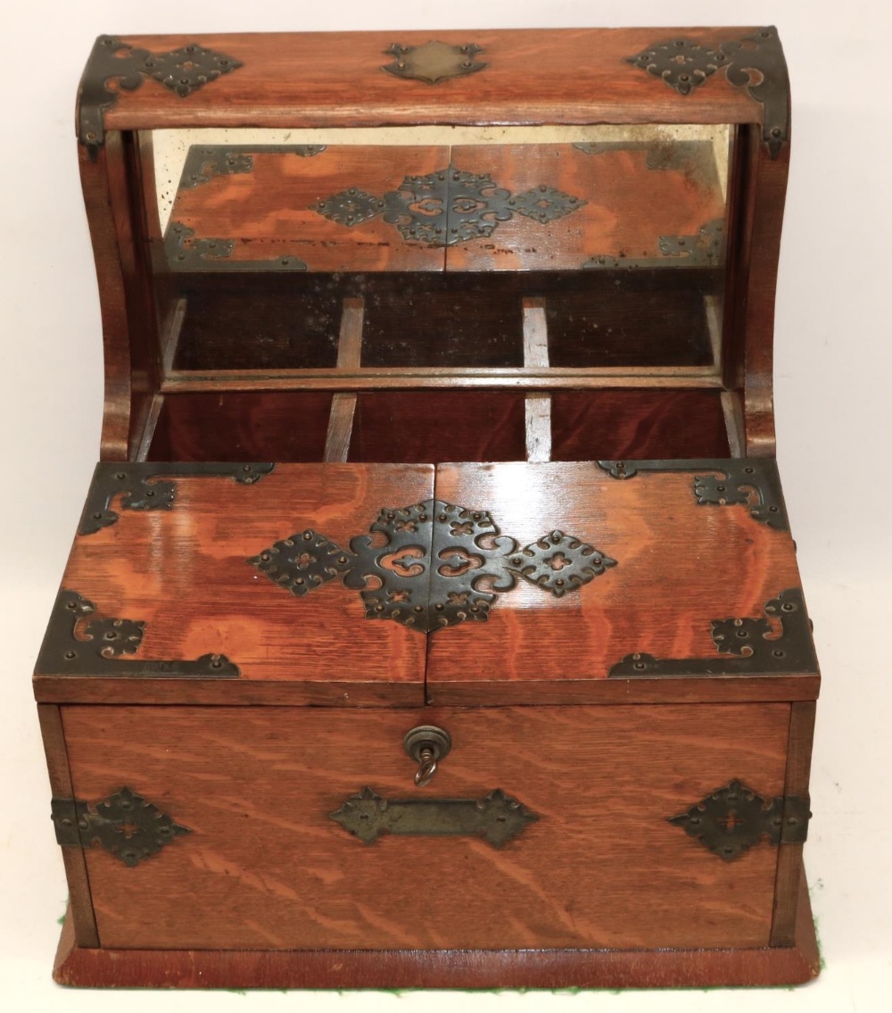 Late 19th century metal mounted oak three bottle tantalus, twin lidded games compartment with fitted