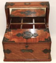 Late 19th century metal mounted oak three bottle tantalus, twin lidded games compartment with fitted