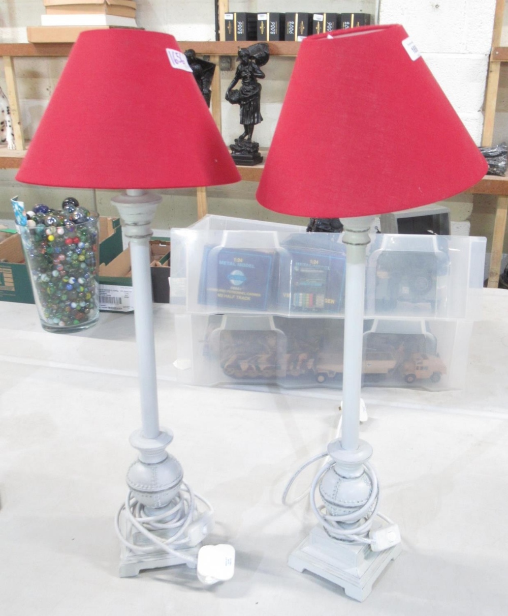 Pair of tall contemporary white painted metal table lamps with red shades, H67cm (2)