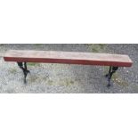 Large garden bench/form with cast iron legs and heavy wooden seat. 199cmx50cm