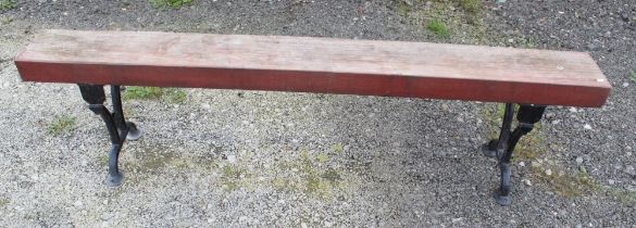 Large garden bench/form with cast iron legs and heavy wooden seat. 199cmx50cm