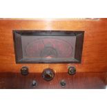 1936 Marconi model 556 domestic radio, Bakelite buttons, original metallic grill and wooden