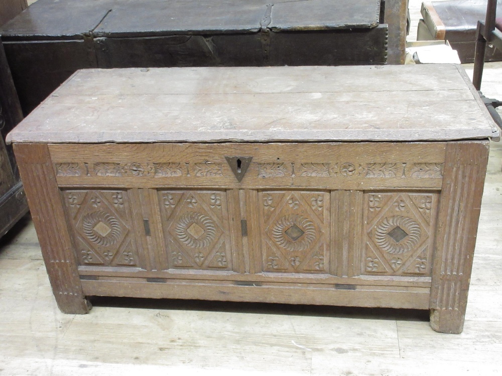 18th century oak coffer, later planked top above four geometric with stop fluted supports, lozenge