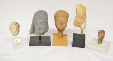 Collection of small stone carvings to include 4 heads and one Romanesque torso (H15), all on plinths