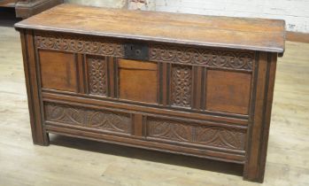18th century oak coffer, hinged lid with incised line detail, panel front carved with lunettes,