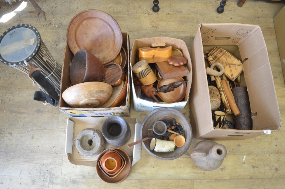 A large collection of carved wooden items from across Africa, including turned plates and bowls,