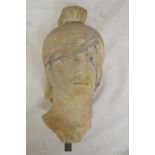Carved marble head of a Roman soldier, damaged and pieced back together. With vertical stand rod, no