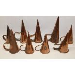 Nine 19th century copper ale warmers with rivetted strap handles, 28cm