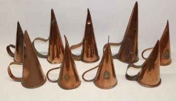 Nine 19th century copper ale warmers with rivetted strap handles, 28cm