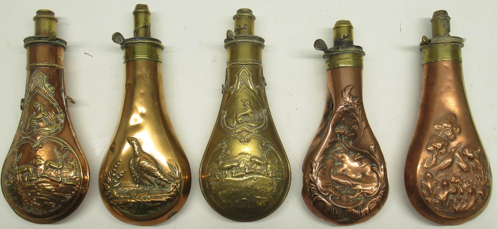 Five 19th century copper and brass embossed powder flasks, decorated with pheasant, wild fowl and