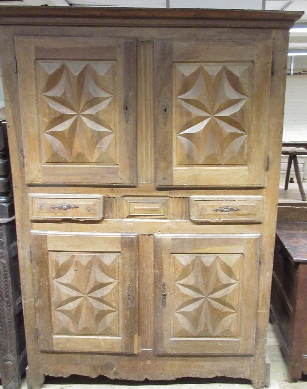 19th century French Provincial cupboard with four geometric panel doors and two drawers, on shaped